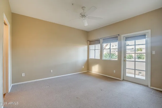 an empty room with windows and entrance