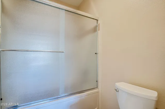 a bathroom with a shower and a toilet