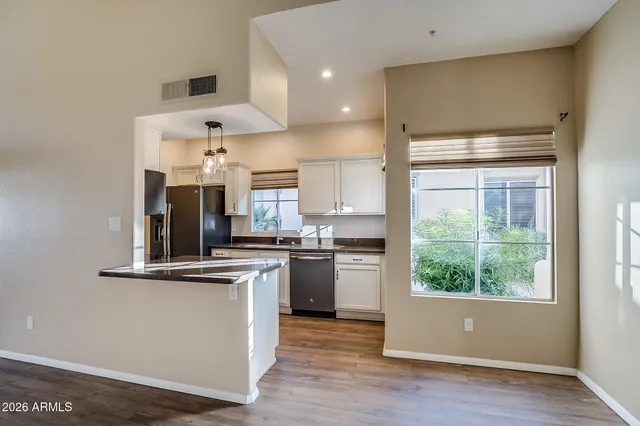 a kitchen with stainless steel appliances granite countertop a stove a sink and a refrigerator