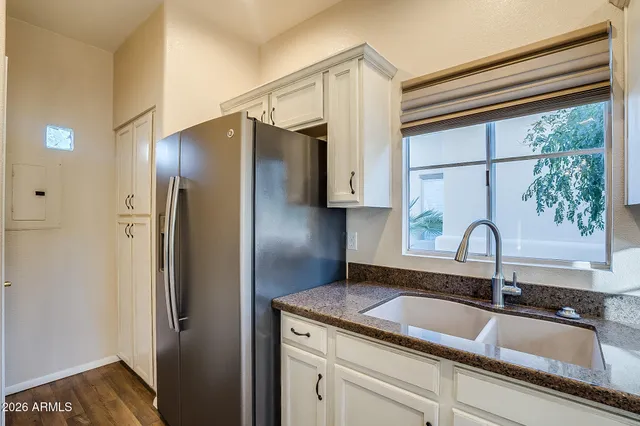 a kitchen with a refrigerator and a sink