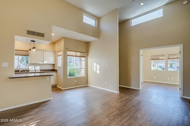 a view of a kitchen with wooden floor and a sink