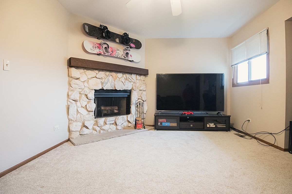 17297 Maple Lane Gurnee, IL 60031 - Photo 14 of 29 a view of a livingroom with a fireplace and a window