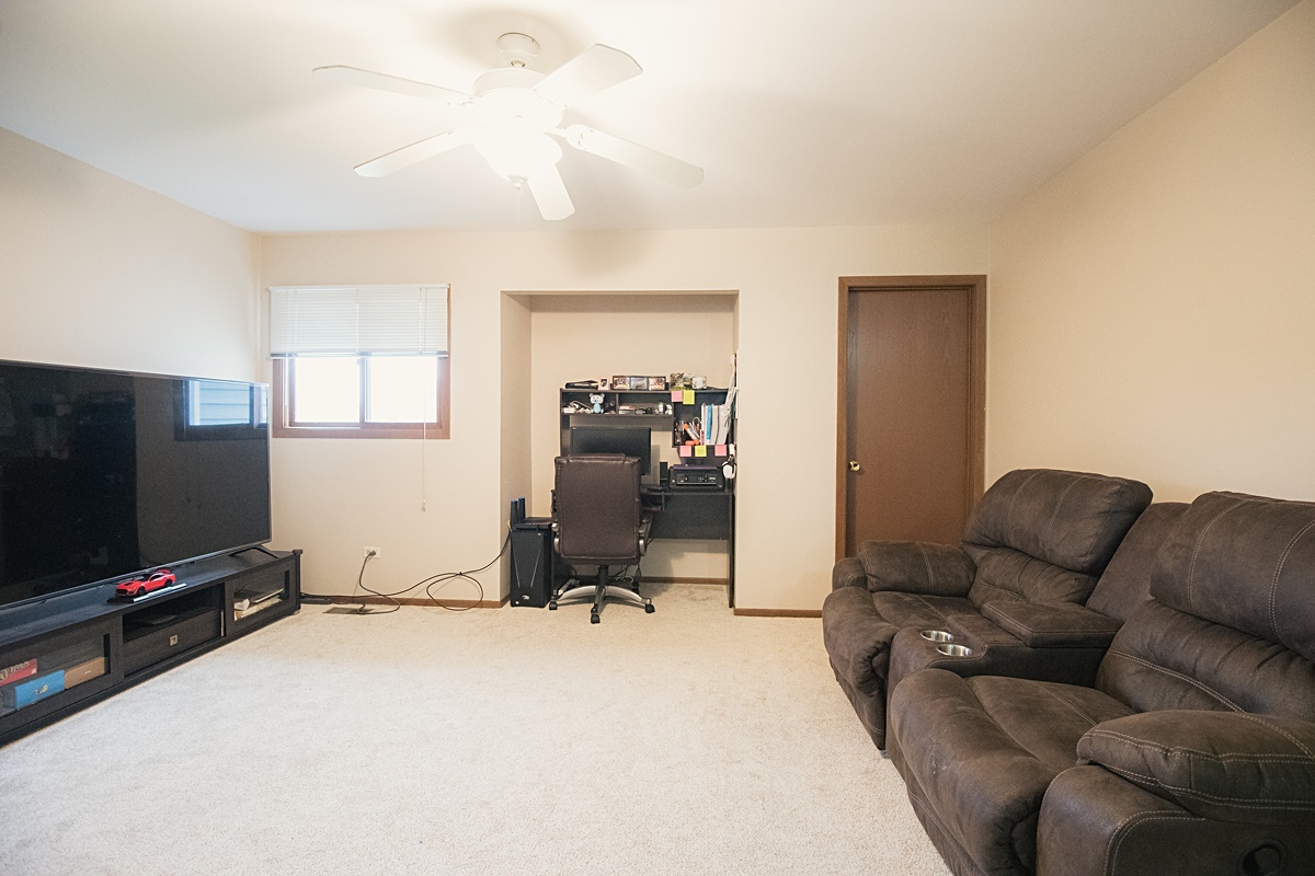 17297 Maple Lane Gurnee, IL 60031 - Photo 16 of 29 a living room with furniture and a flat screen tv