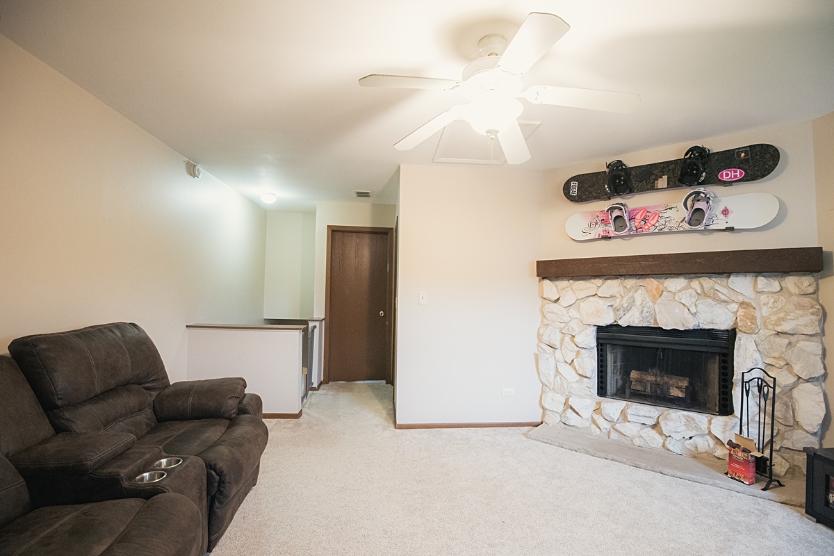 17297 Maple Lane Gurnee, IL 60031 - Photo 17 of 29 a living room with furniture and a fireplace