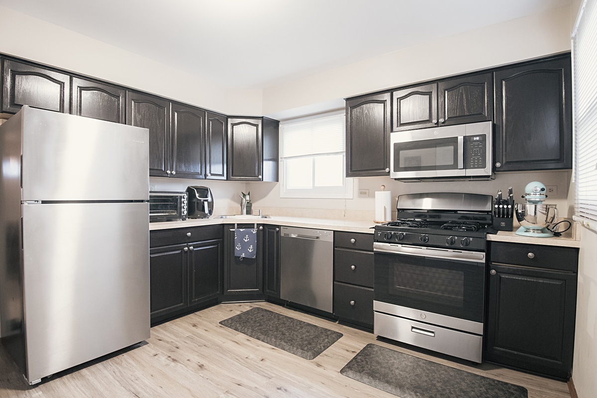 17297 Maple Lane Gurnee, IL 60031 - Photo 25 of 29 a kitchen with stainless steel appliances granite countertop a refrigerator stove microwave and sink