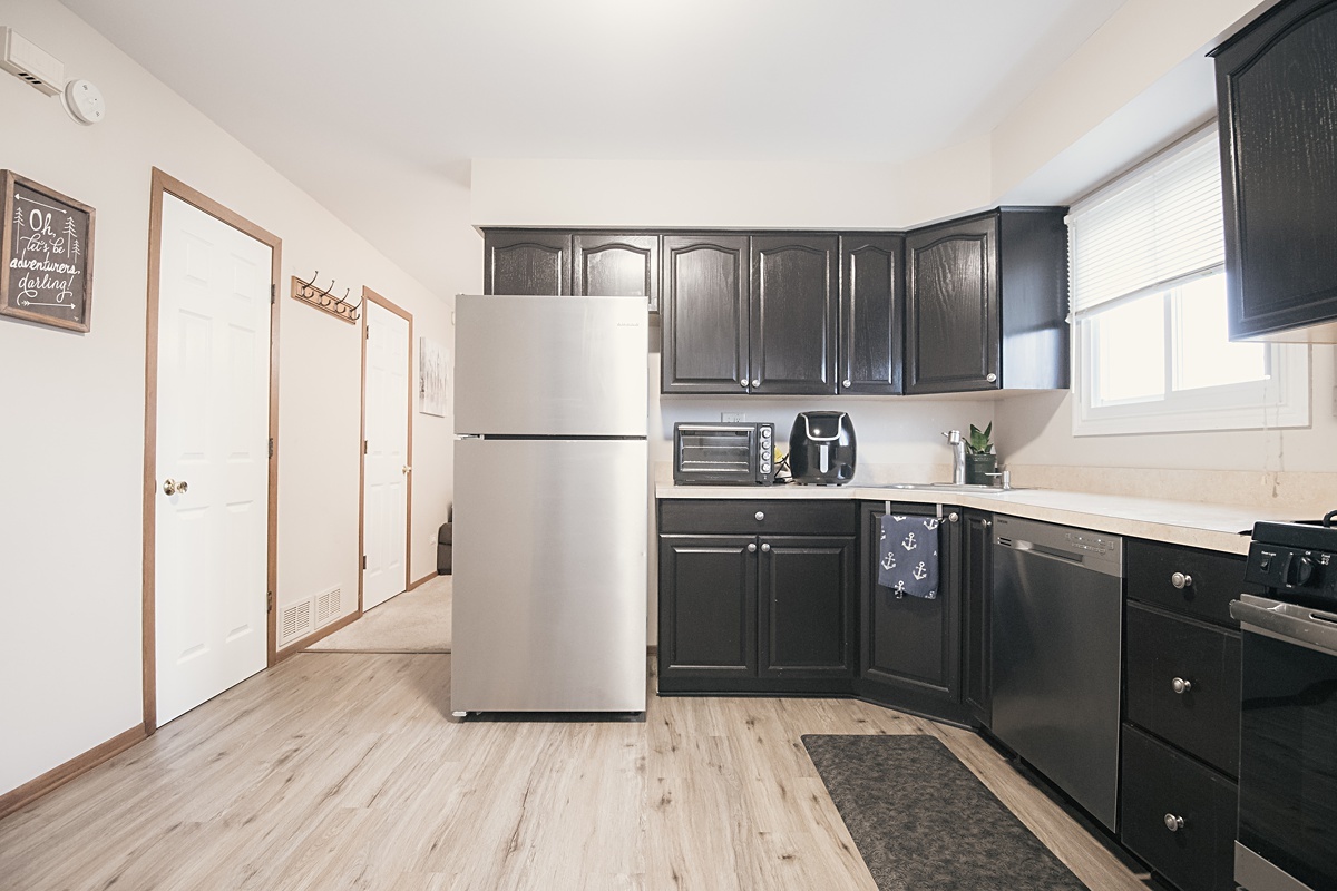 17297 Maple Lane Gurnee, IL 60031 - Photo 27 of 29 a kitchen with a refrigerator a sink and cabinets