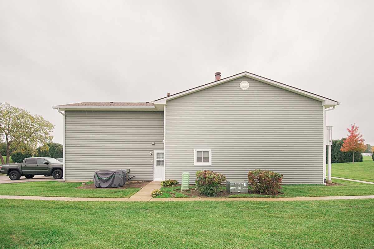 17297 Maple Lane Gurnee, IL 60031 - Photo 4 of 29 a front view of a house with a yard and garage