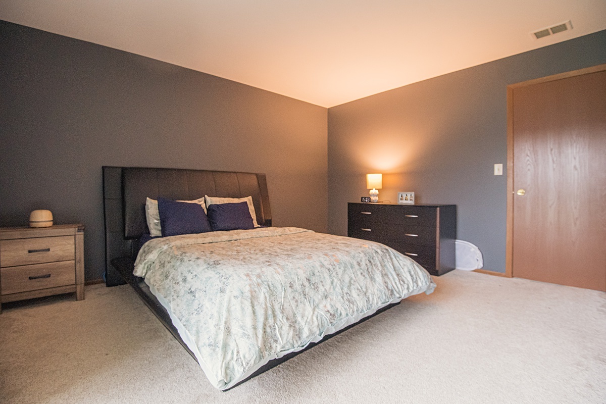 17297 Maple Lane Gurnee, IL 60031 - Photo 7 of 29 a bedroom with a bed and lamp