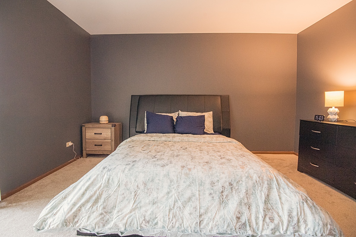 17297 Maple Lane Gurnee, IL 60031 - Photo 8 of 29 a bedroom with a bed and a tv