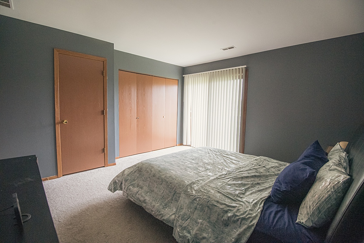 17297 Maple Lane Gurnee, IL 60031 - Photo 9 of 29 a bedroom with a bed and a window