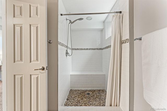 a bathroom with a glass shower door
