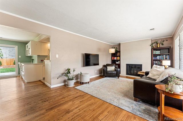 a living room with furniture wooden floor and a fireplace