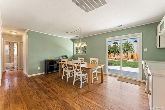 a dining room with furniture and wooden floor