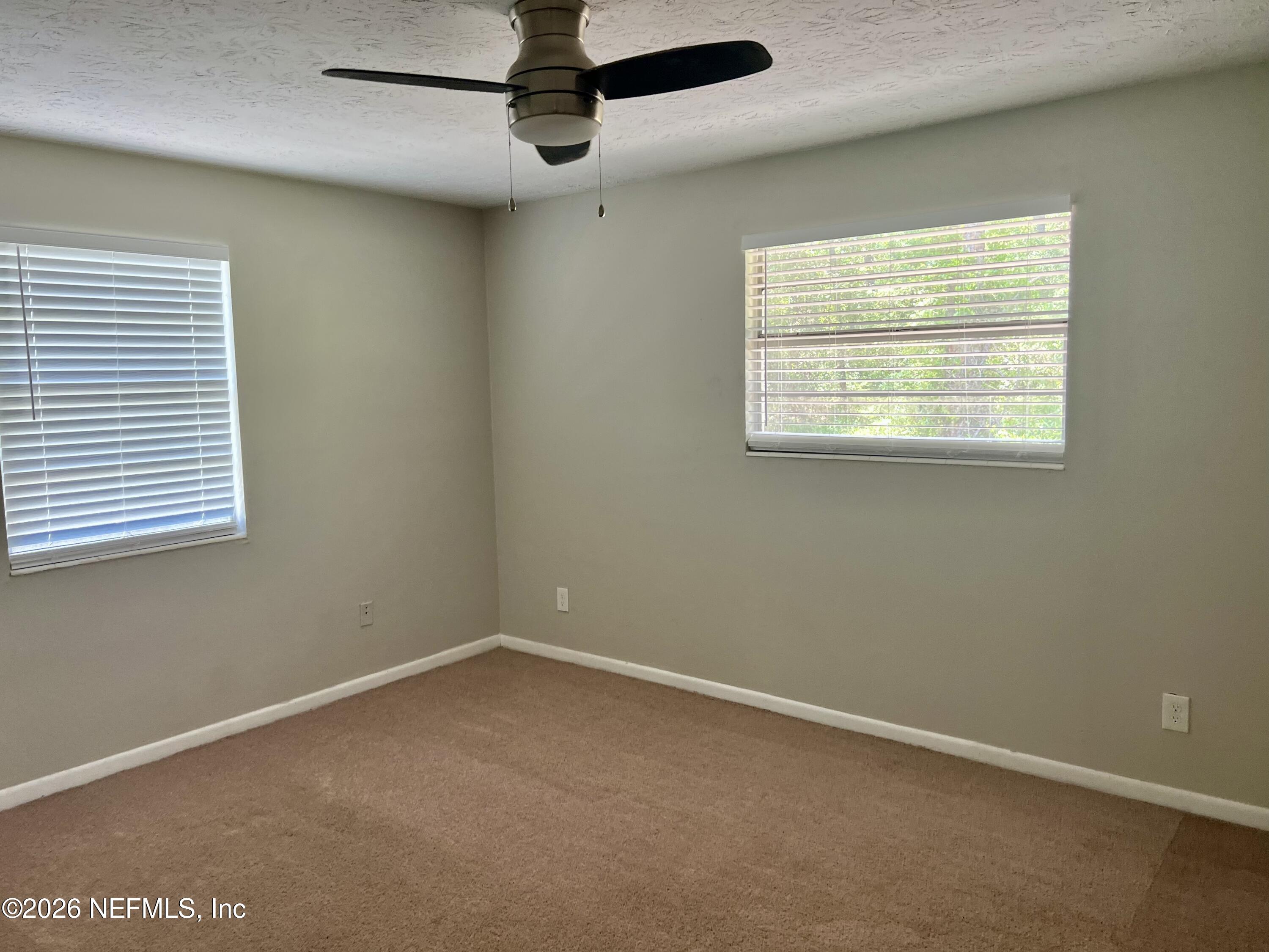10964 Bacall Road West Jacksonville, FL 32218 - Photo 10 of 19 en empty room with windows