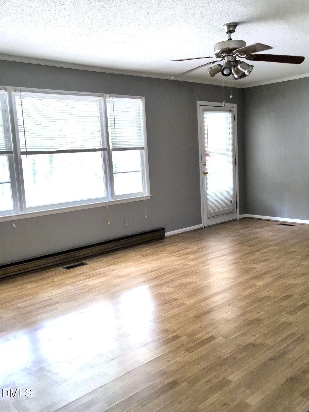 323 Ranch Farm Road Raleigh, NC 27603 - Photo 18 of 42 a view of room window and wooden floor