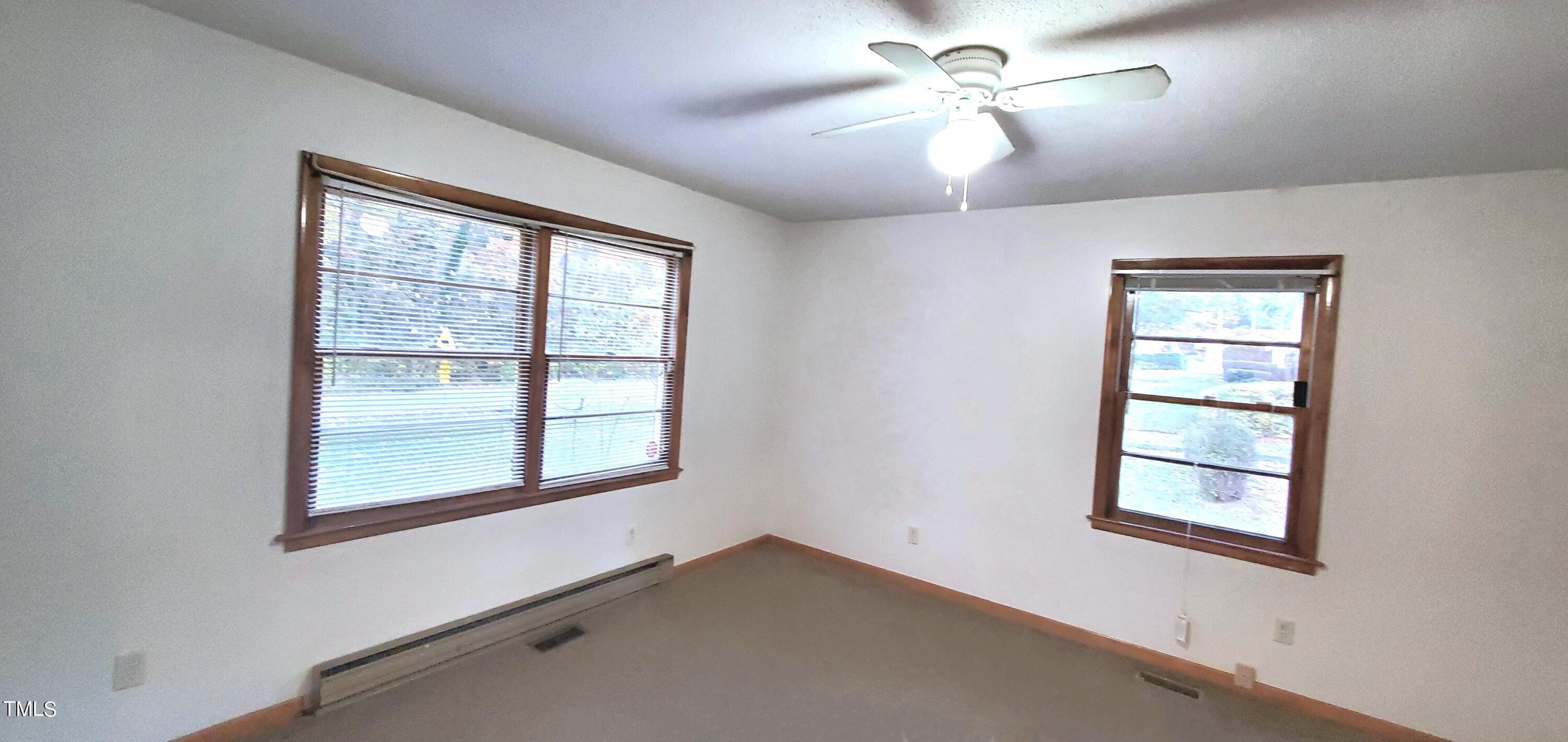 323 Ranch Farm Road Raleigh, NC 27603 - Photo 38 of 42 a view of an empty room with a window and a ceiling fan
