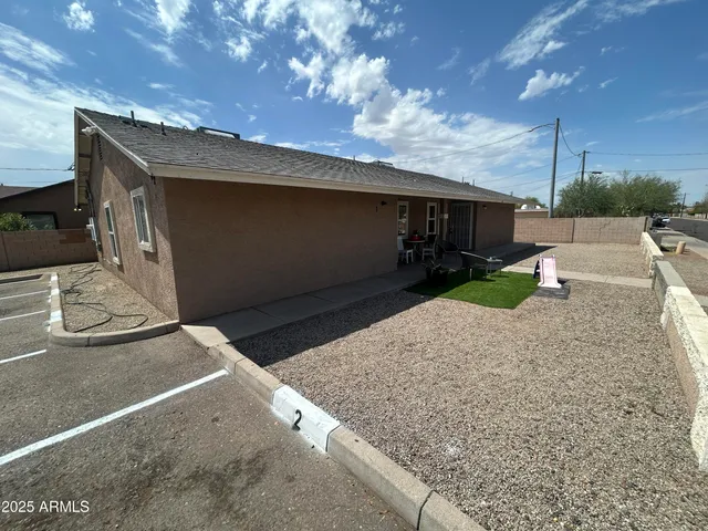 a backyard of a house with yard fire pit and outdoor seating