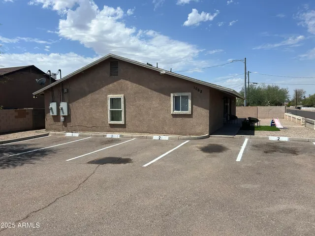 a backyard of a house with table and chairs