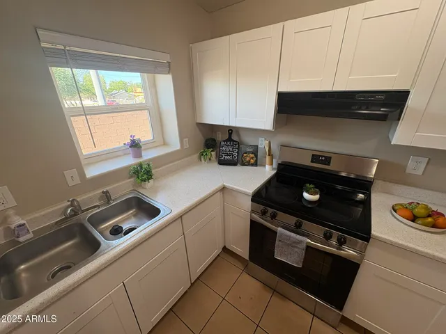 a kitchen with a stove and a sink
