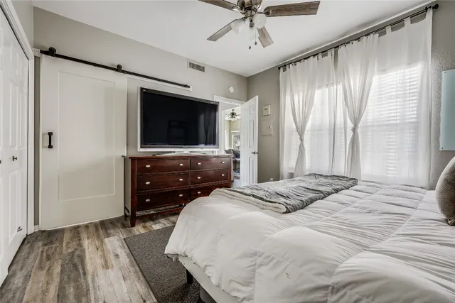 a bedroom with a bed and a flat screen tv