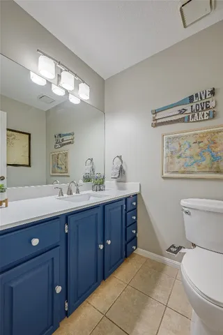 a spacious bathroom with a toilet sink and mirror