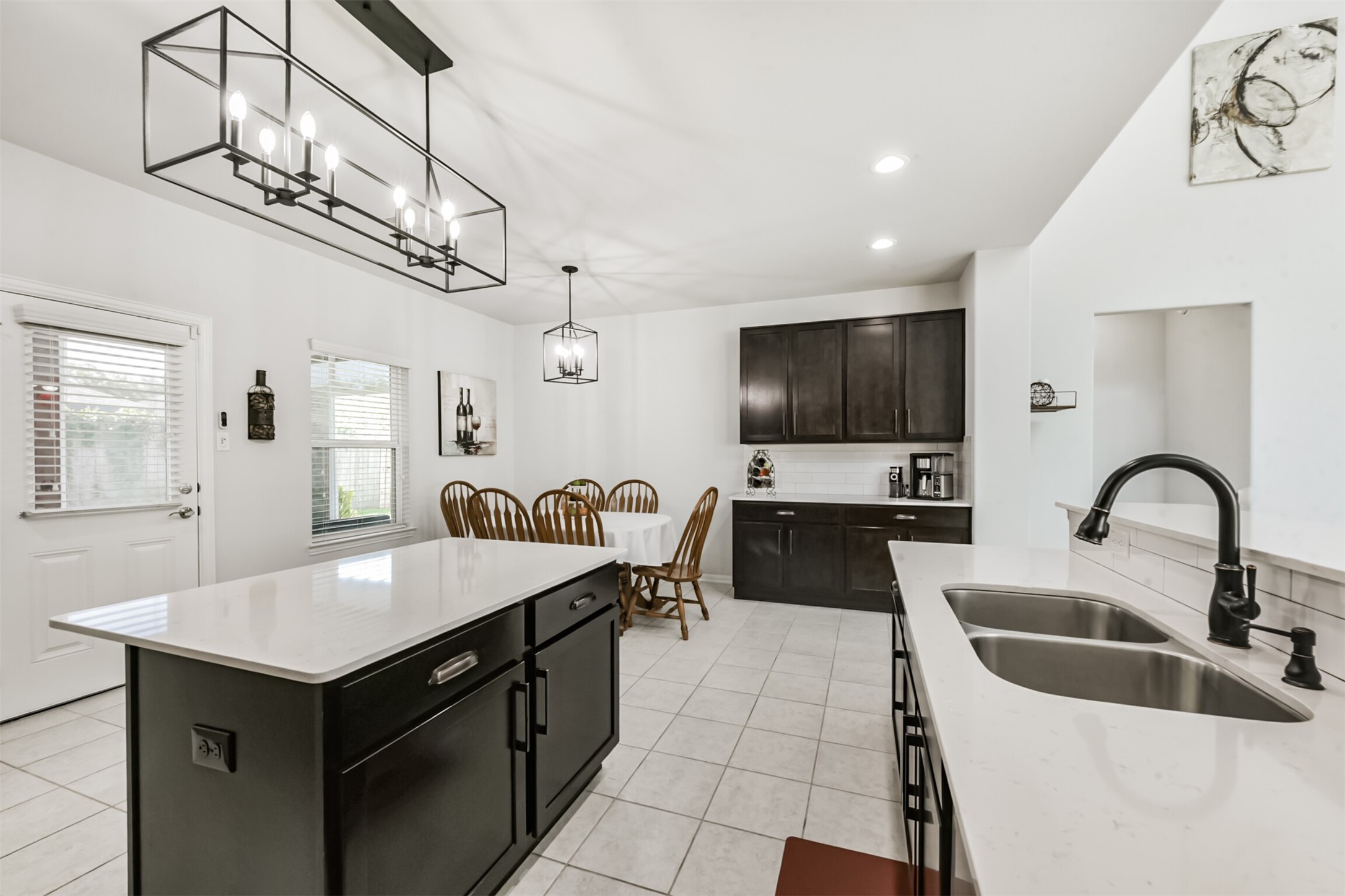 10018 Chase Court Baytown, TX 77521 - Photo 1 of 50 a kitchen with a stove a kitchen island a sink dishwasher a dining table and chairs with wooden floor