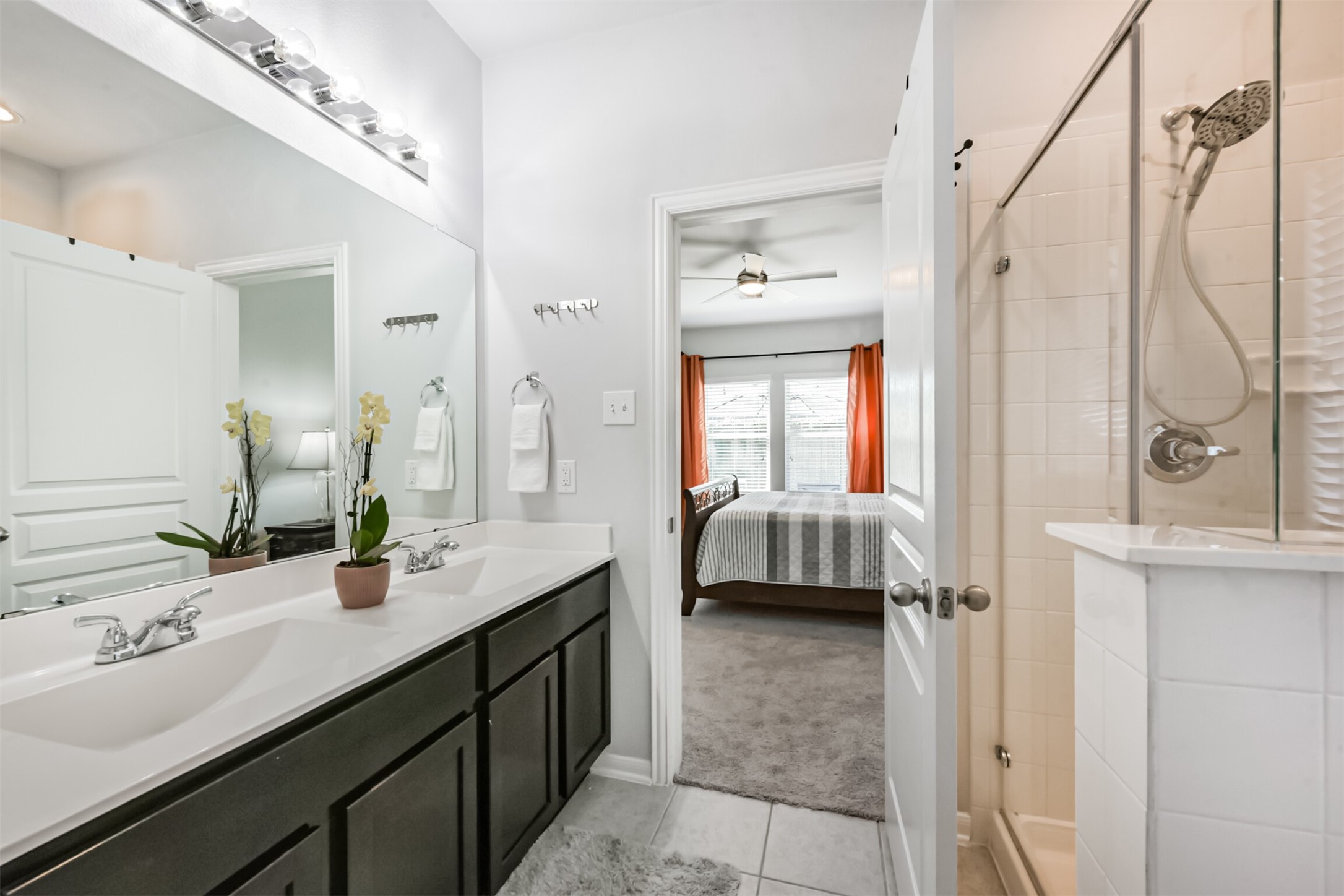 10018 Chase Court Baytown, TX 77521 - Photo 24 of 50 a en suite bathroom with a double vanity sink a mirror and shower
