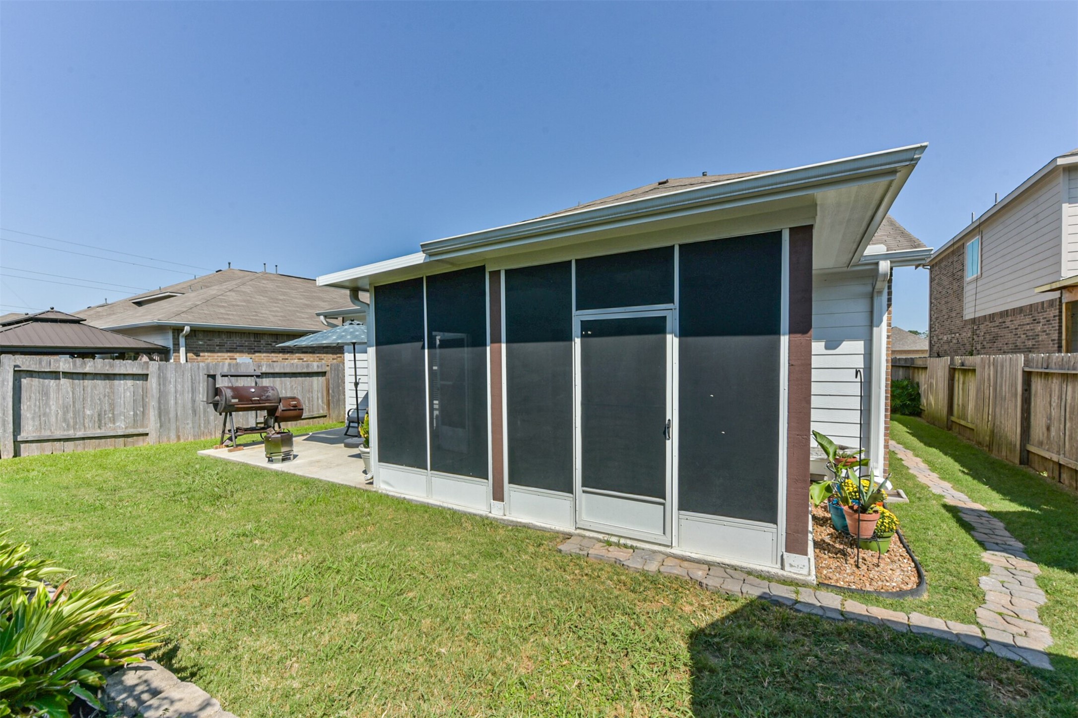 10018 Chase Court Baytown, TX 77521 - Photo 39 of 50 a view of a backyard with table and chairs and potted plants