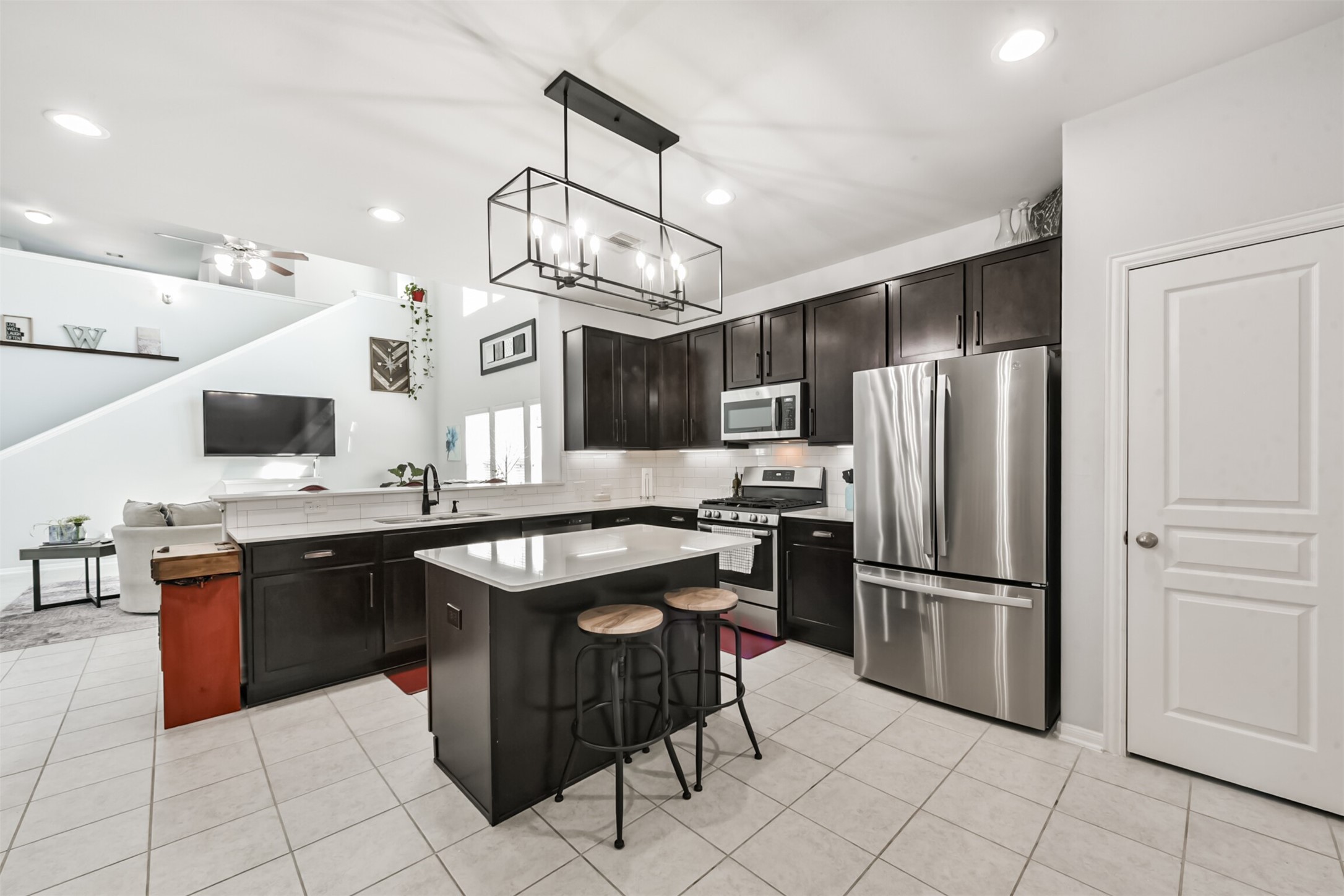 10018 Chase Court Baytown, TX 77521 - Photo 4 of 50 a kitchen with stainless steel appliances granite countertop a sink and a refrigerator