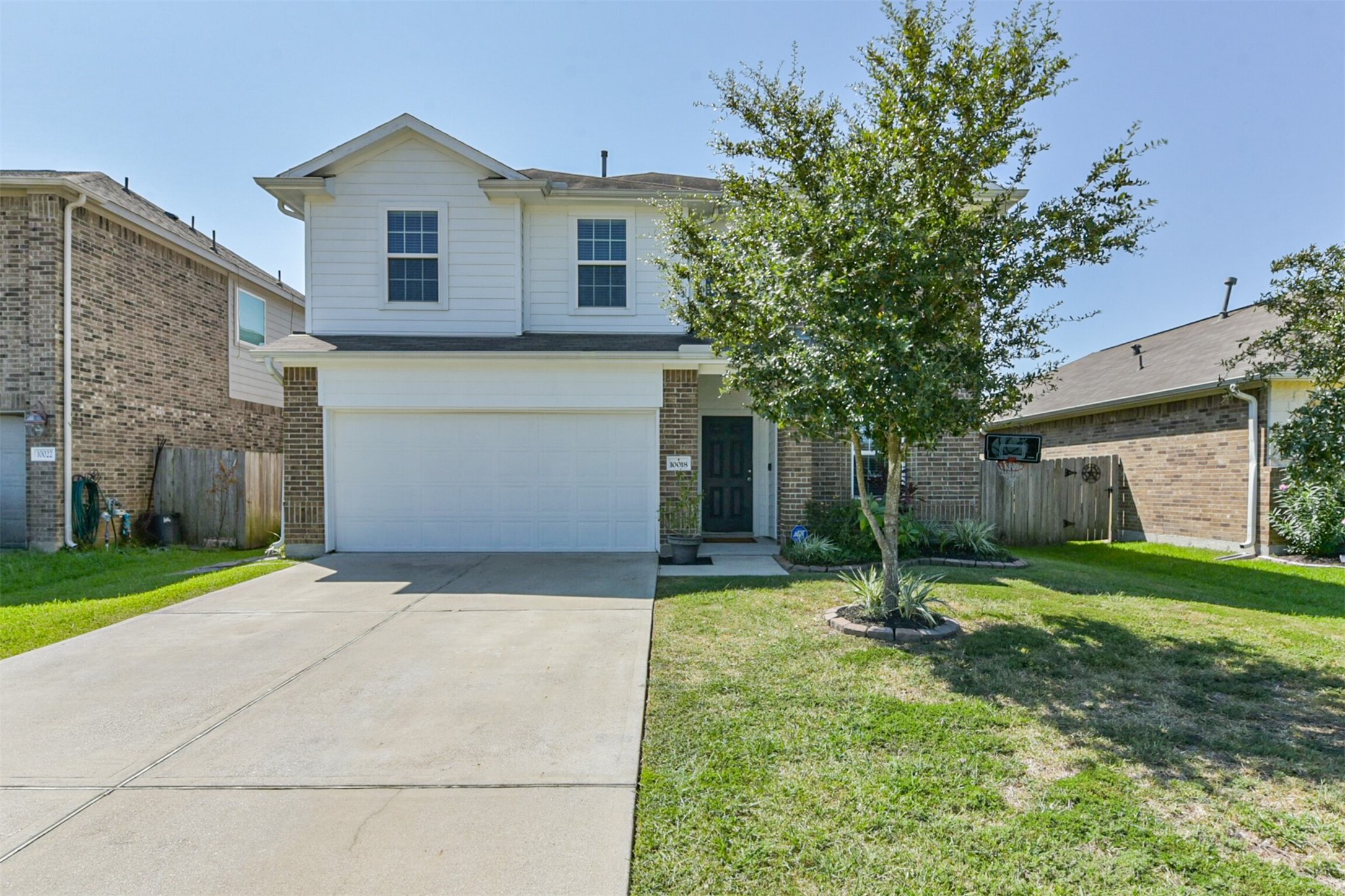 10018 Chase Court Baytown, TX 77521 - Photo 41 of 50 a front view of a house with a yard and garage