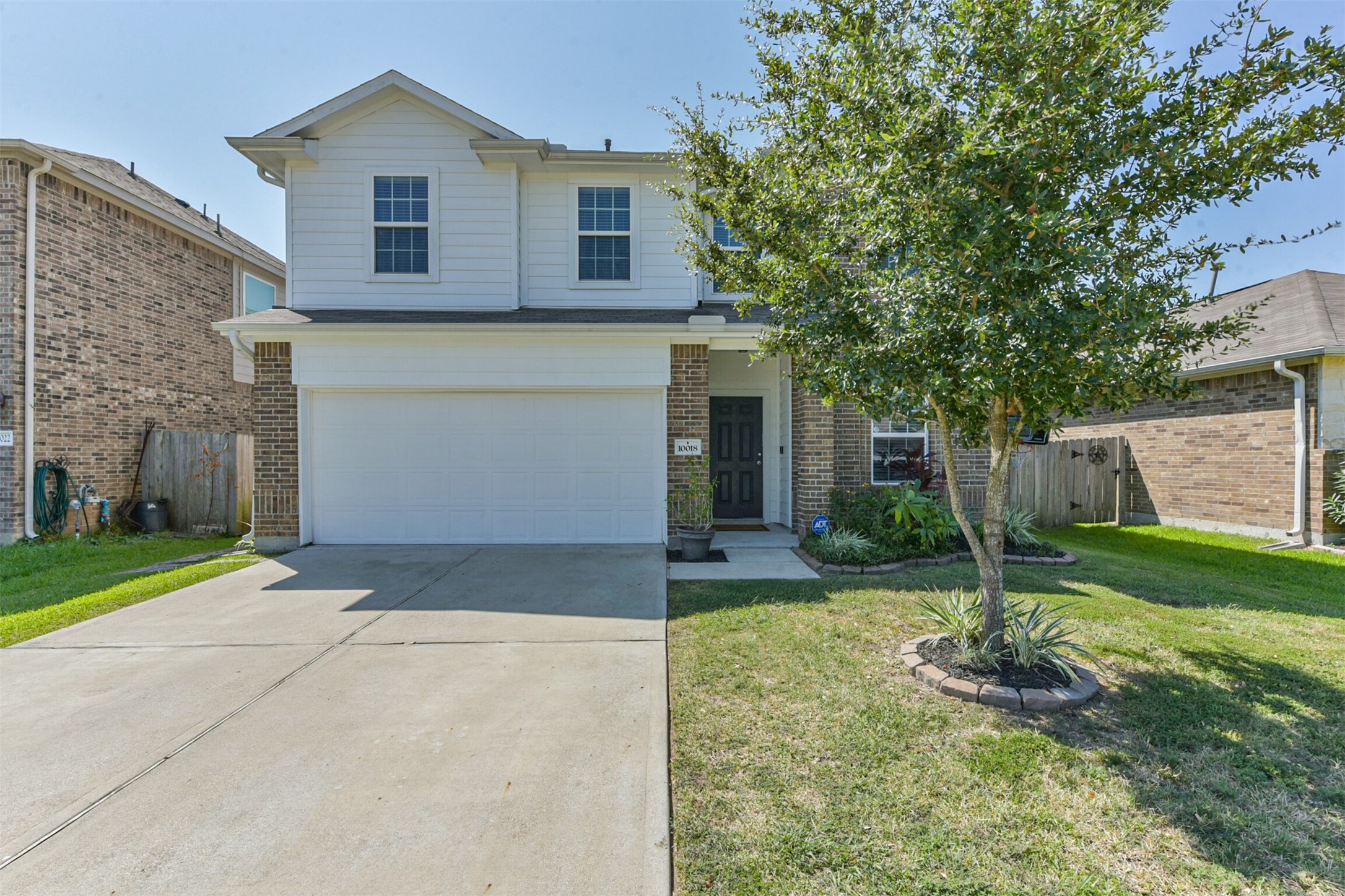 10018 Chase Court Baytown, TX 77521 - Photo 42 of 50 a front view of a house with a yard and garage