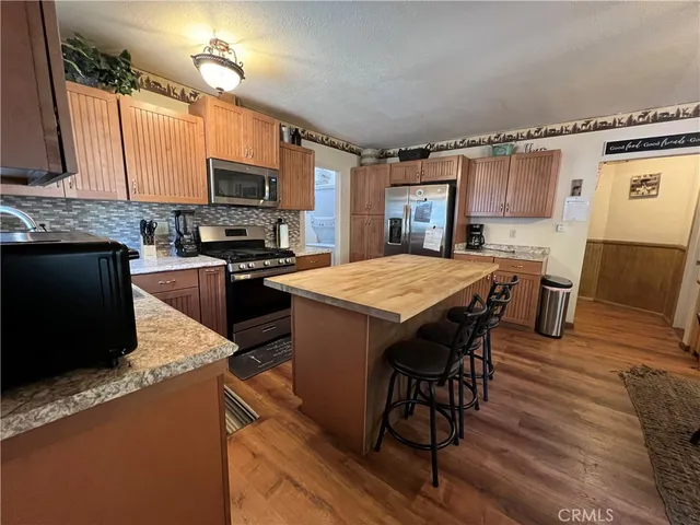 a kitchen with refrigerator cabinets and wooden floor