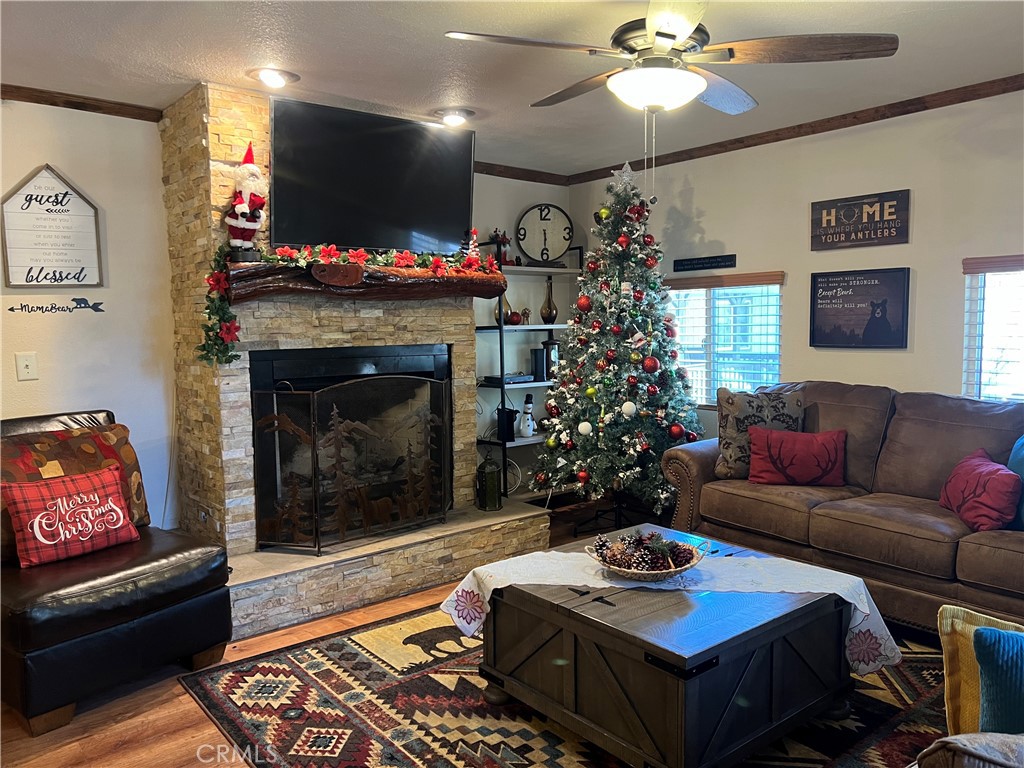 39307 Lark Road Big Bear Lake, CA 92315 - Photo 26 of 35 a living room with furniture a flat screen tv and a fireplace