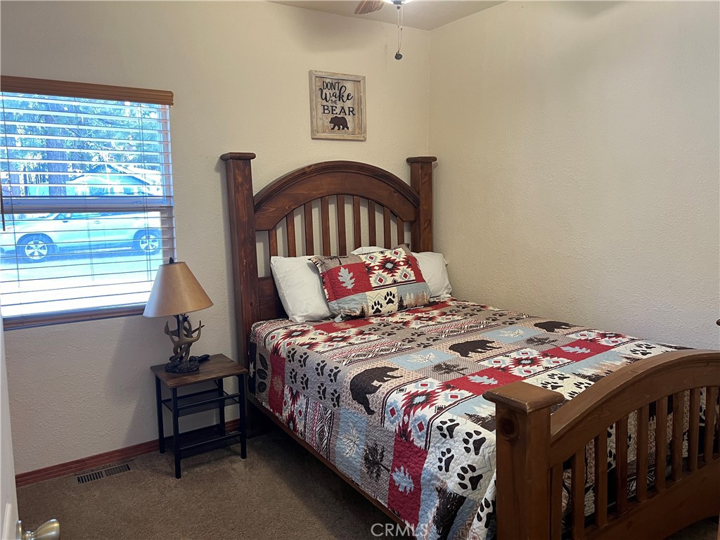 39307 Lark Road Big Bear Lake, CA 92315 - Photo 29 of 35 a bedroom with a bed and a window