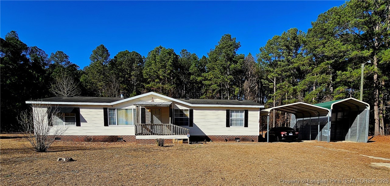 2156 Maxton Street Autryville, NC 28318 - Photo 1 of 38 a view of house with outdoor space and trees in the background