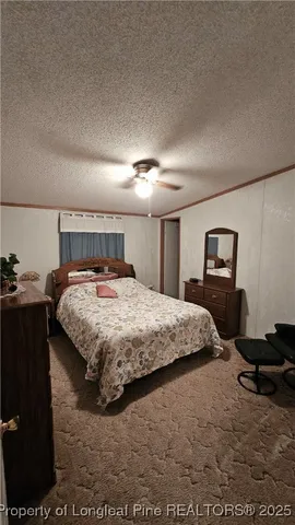 a bedroom with a bed and a lamp on dresser