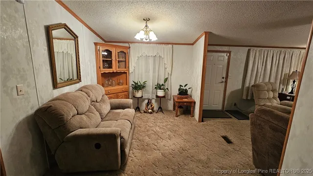 a living room with furniture a window and a flat screen tv