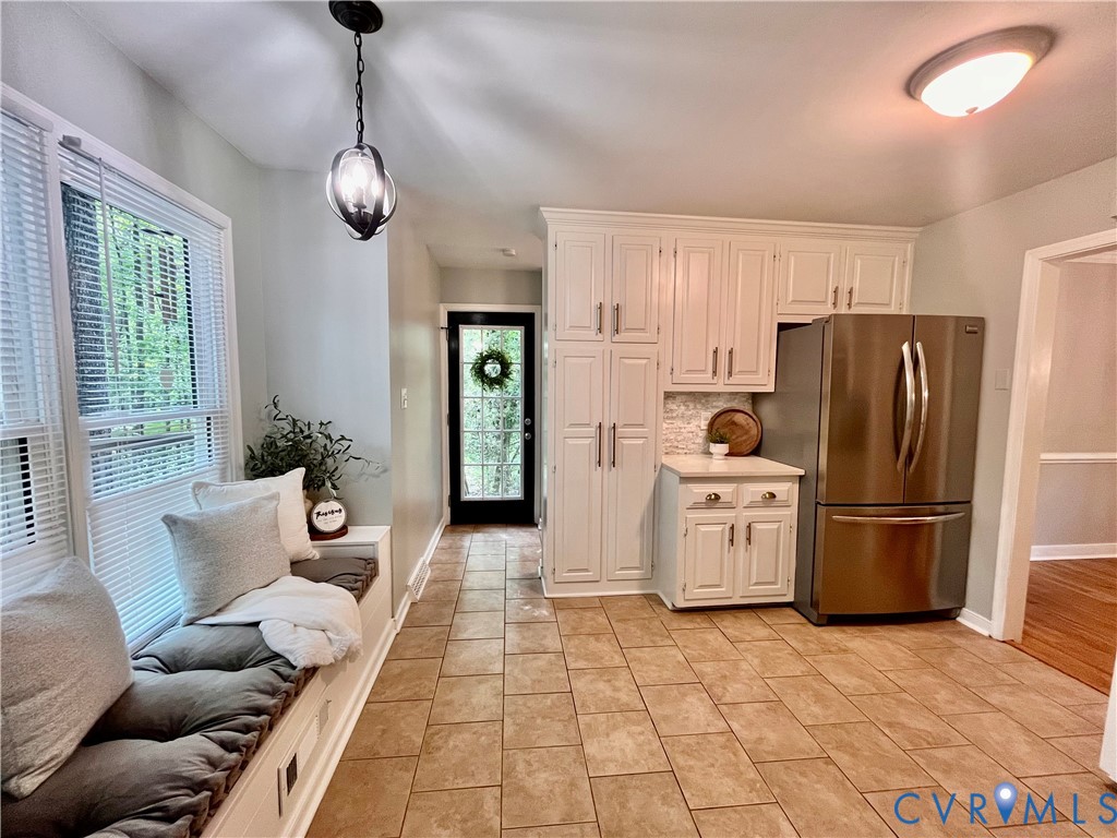 13700 Watkins Glen Road Midlothian, VA 23112 - Photo 5 of 23 a living room with furniture a refrigerator and a chandelier