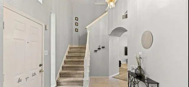 a view of a hallway with wooden floor and entryway