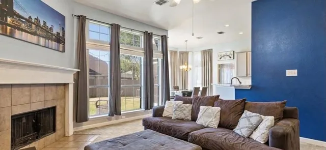 a living room with furniture and a fireplace