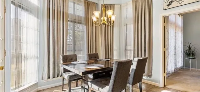 a view of a dining room with furniture and window
