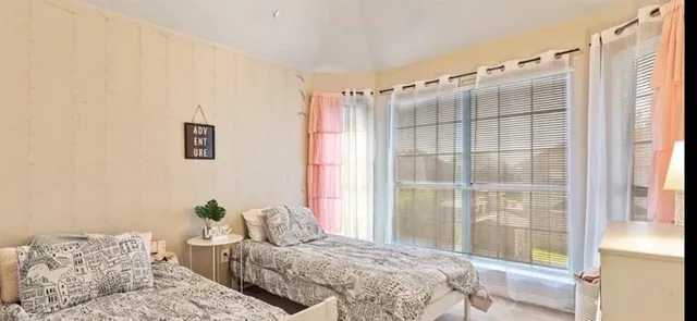 a bedroom with a bed and a window