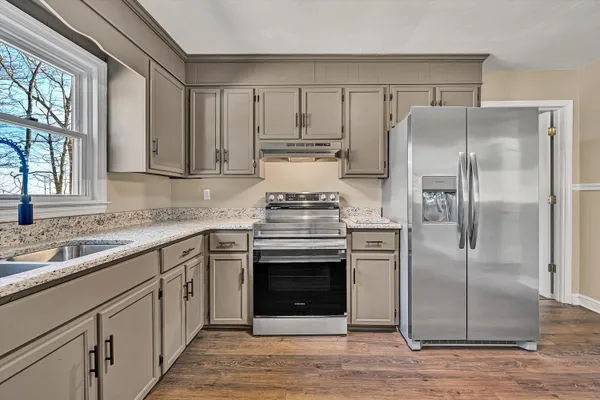 a view closed with granite countertop a sink and a window