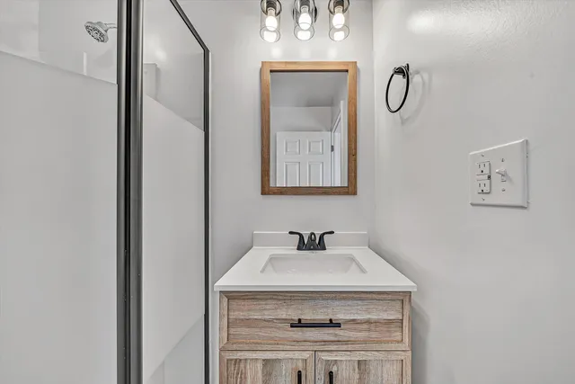 a bathroom with a glass shower door