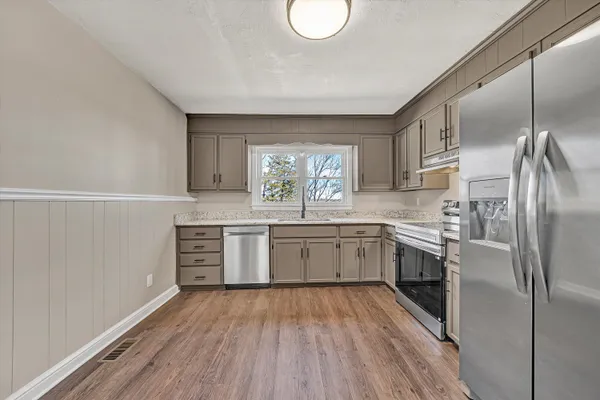 a kitchen with a refrigerator and a sink