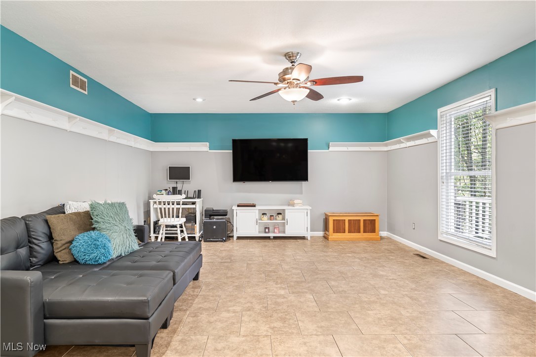 155 Ridgewood Boulevard Belpre, OH 45714 - Photo 17 of 49 Tiled living room featuring a ceiling fan and baseboards