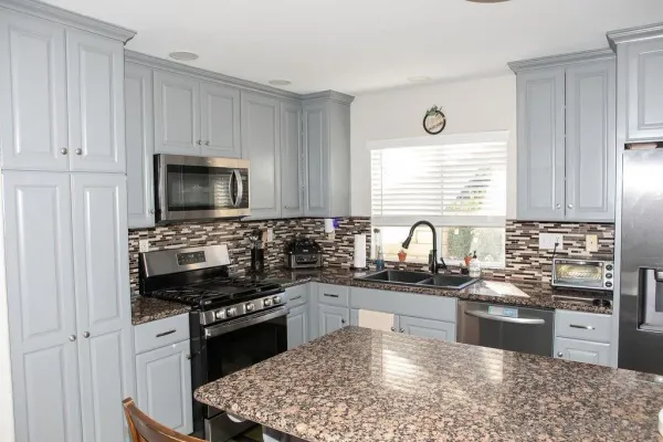 a kitchen with a stove a sink and a microwave