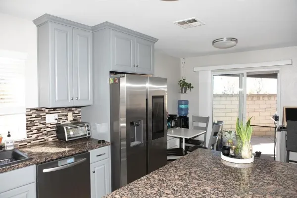 a kitchen with a refrigerator and a stove