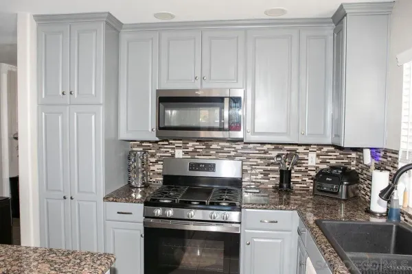 a kitchen with cabinets appliances and a sink