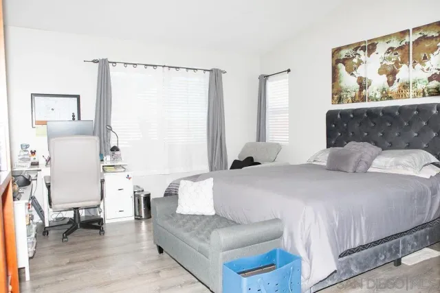 a bedroom with a large bed and a couch